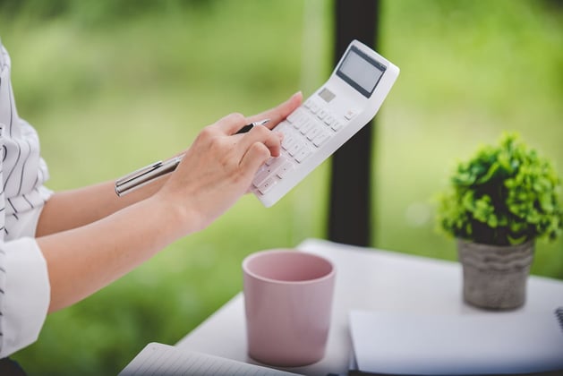 A property owner calculating ROI on a calculator.