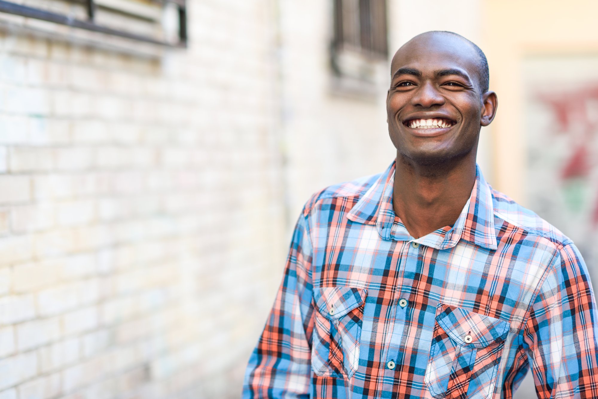 Black man wearing casual clothes in urban background