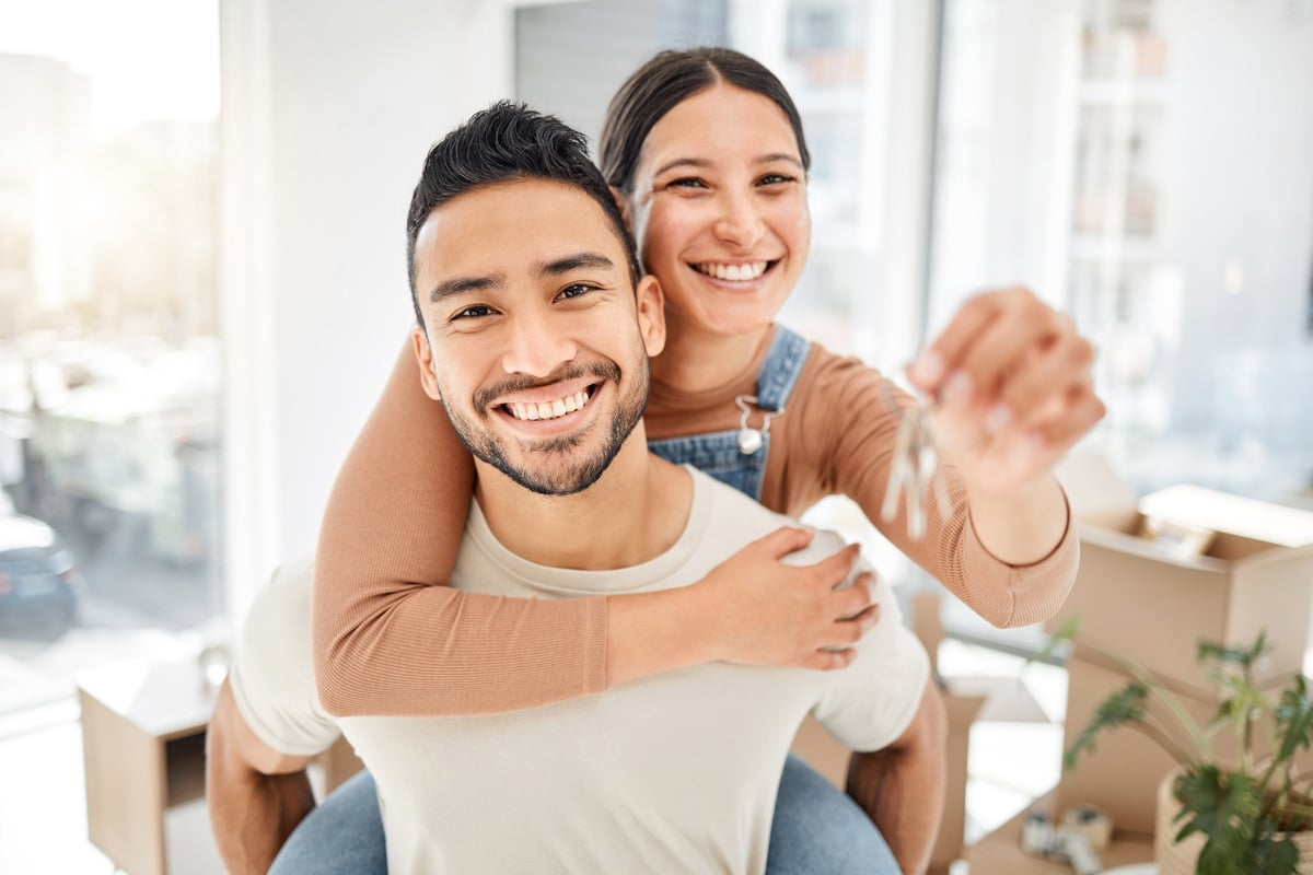 A happy man and woman holding keys