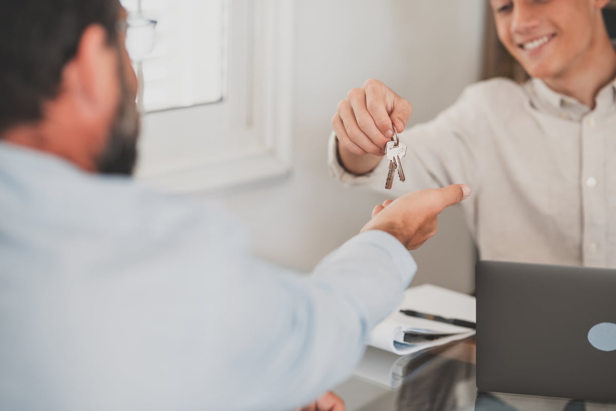 A man giving keys to a tenant