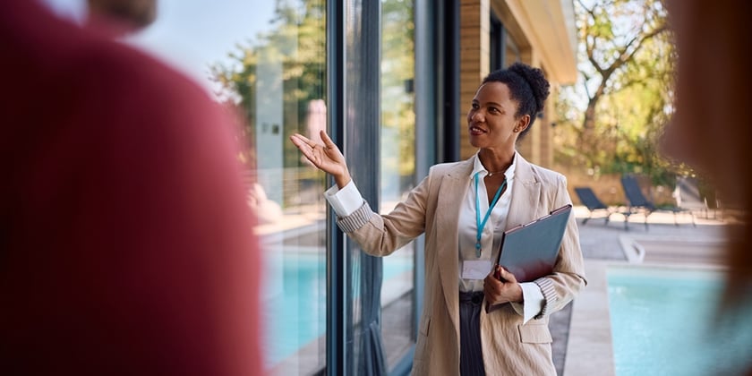 A real estate agent showing a new house to tenants