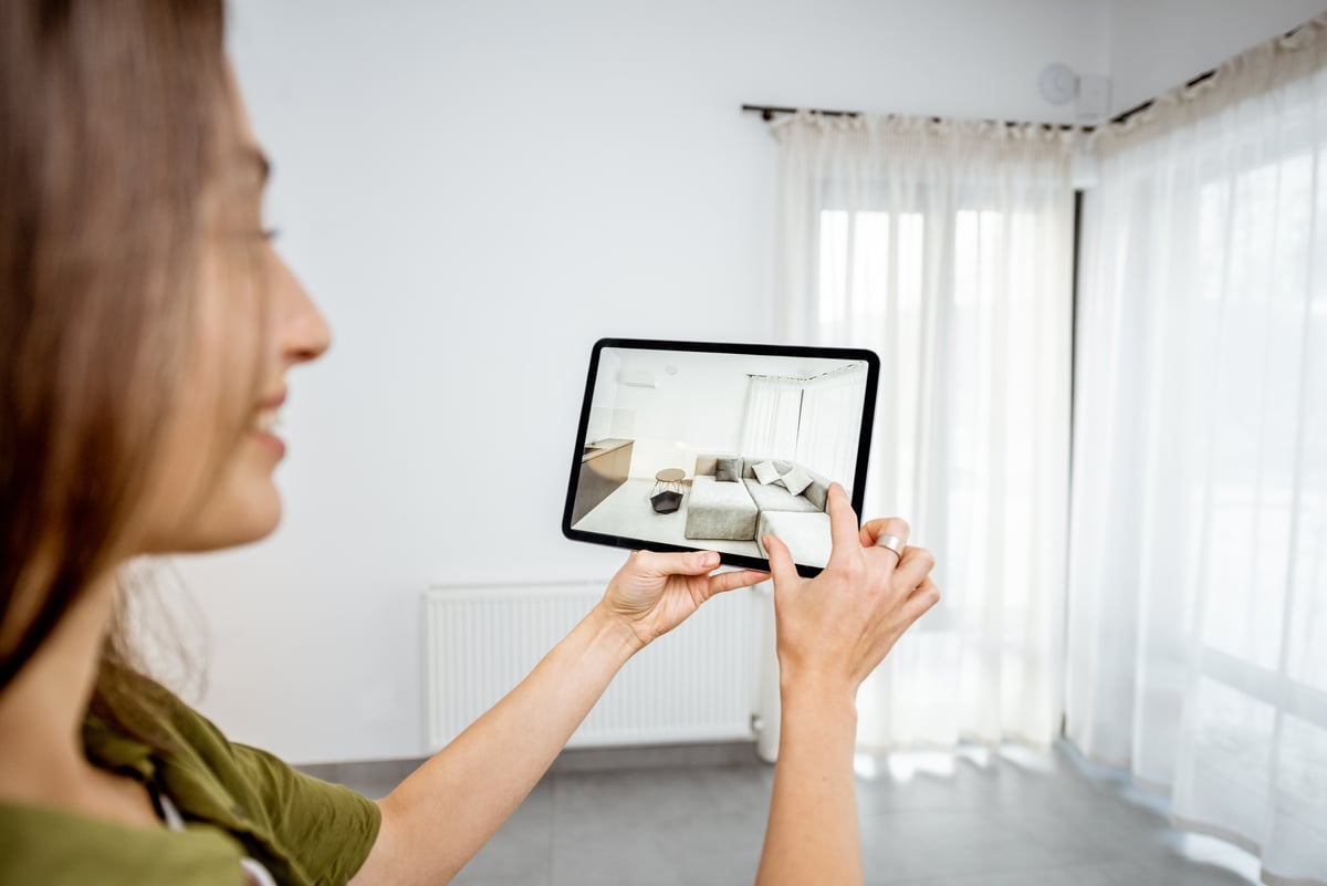 A woman looking at a property listing on a tablet