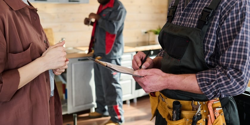 Handyman working on a tenant's kitchen
