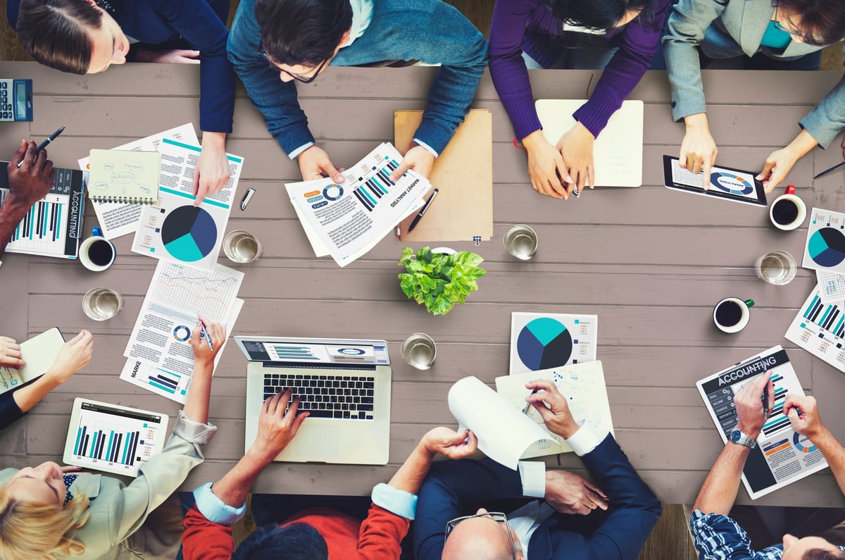 Business people working around a table, rental market analysis concept. 