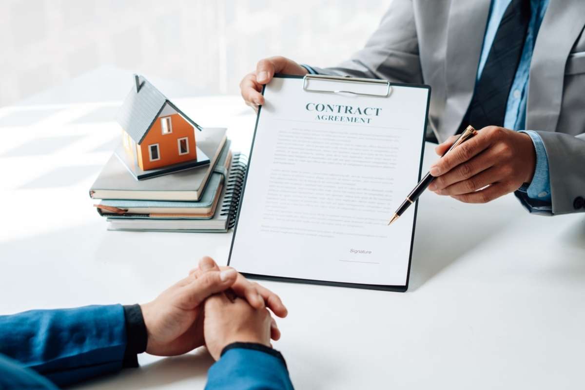 Buying a Home or Insurance, an insurance agent explains the lease agreement to a client before making a contract