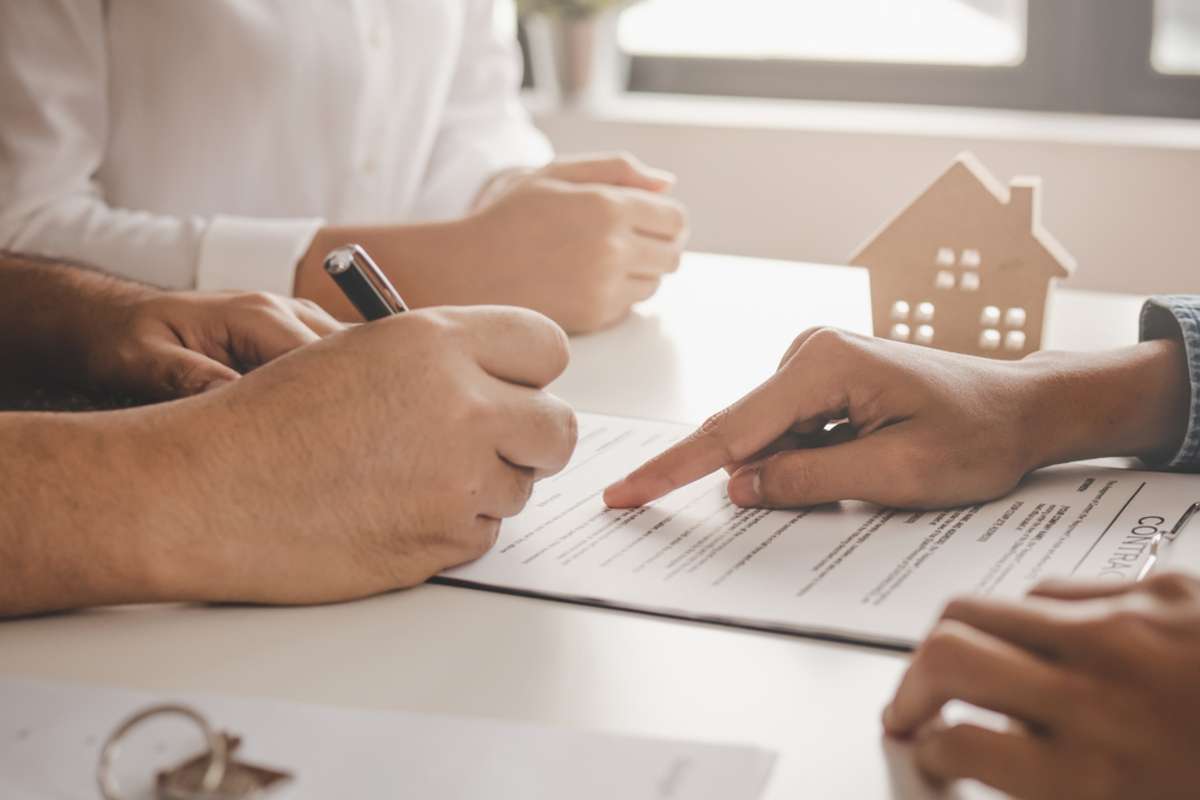 Close-up of hands and a contract, Settle property management concept. 