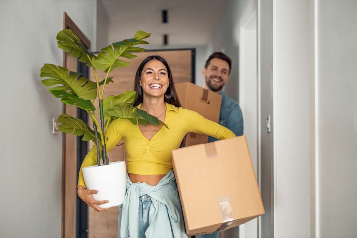 Happy couple moves into a home after completing a rental application template