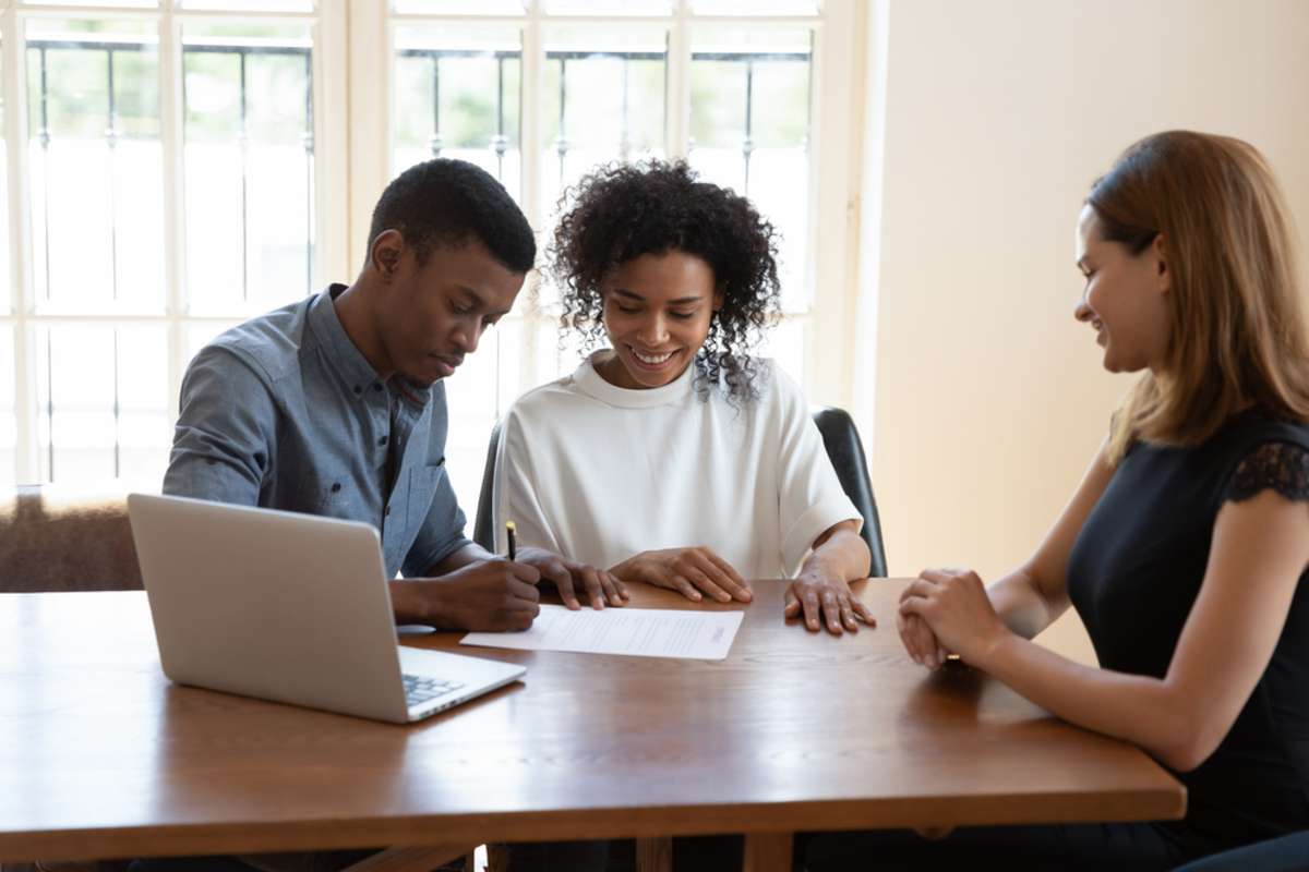 Happy couple signs to renew a lease agreement