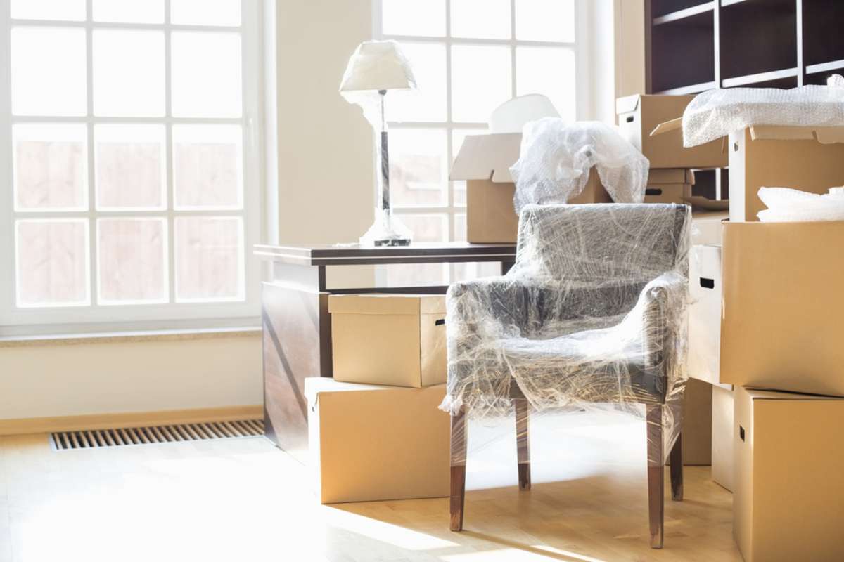 Moving boxes and furniture in a home, removing belongings for the eviction process concept. 