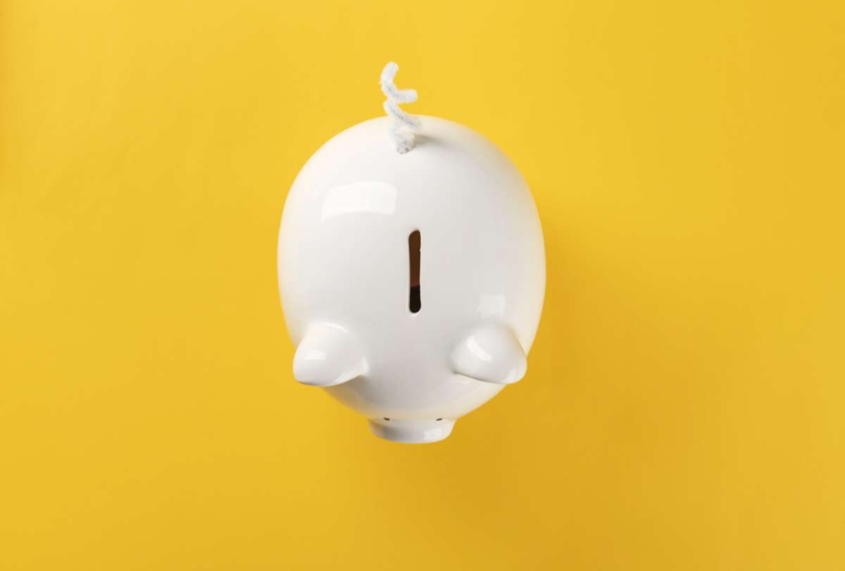 Piggy bank on yellow background, better ROI from residential property management Seattle concept