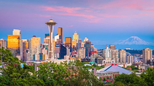 Seattle, Washington, USA downtown skyline at night with Mt. Rainier