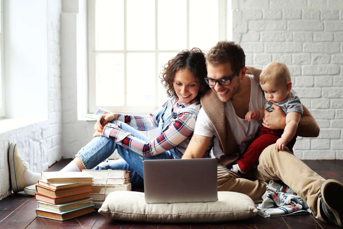 Young happy family relaxing at home, Seattle property management company concept