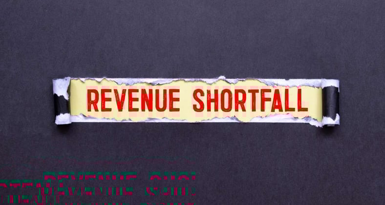 The words Revenue Shortfall written on paper