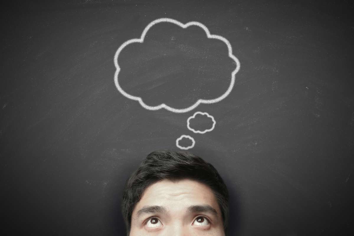 Thinking man with thinking bubble on blackboard background