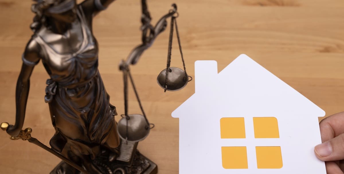 A law scale next to a small home
