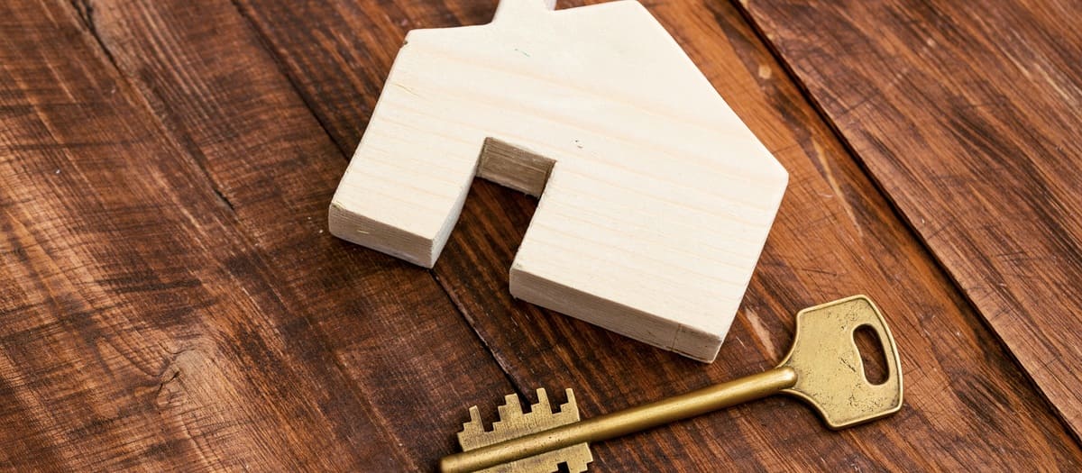 A wooden house next to a key