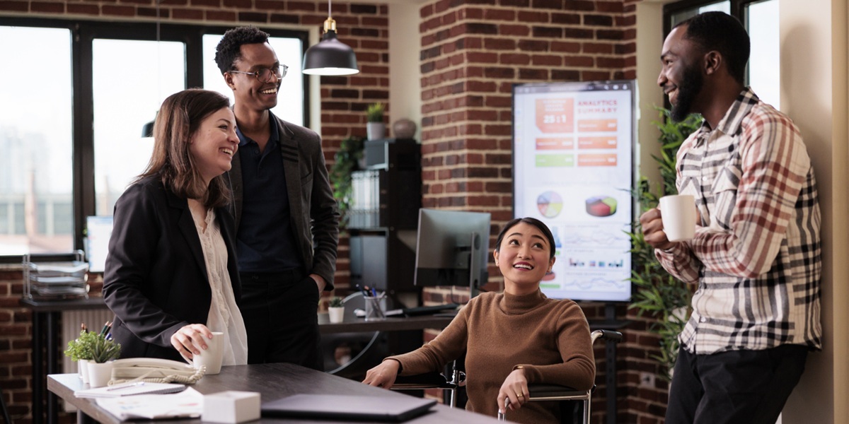 Coworkers Enjoying Casual Conversation in Modern Office Space