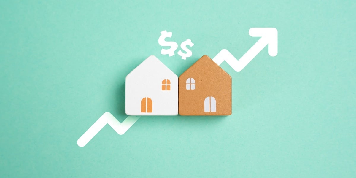 Dollar signs and an up arrow around small houses
