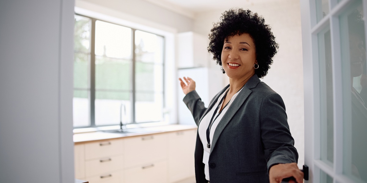 Woman Showing Modern Kitchen in New Home