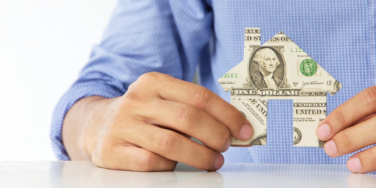 Hand holding banknote house icon