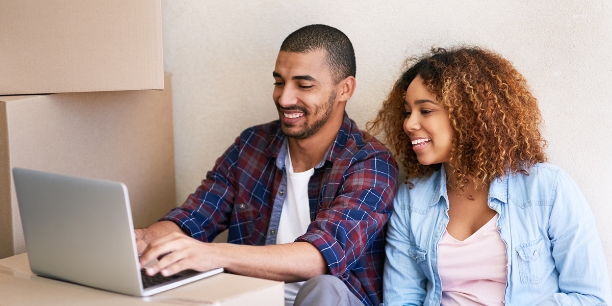 Happy Young Couple Moving Into New Home