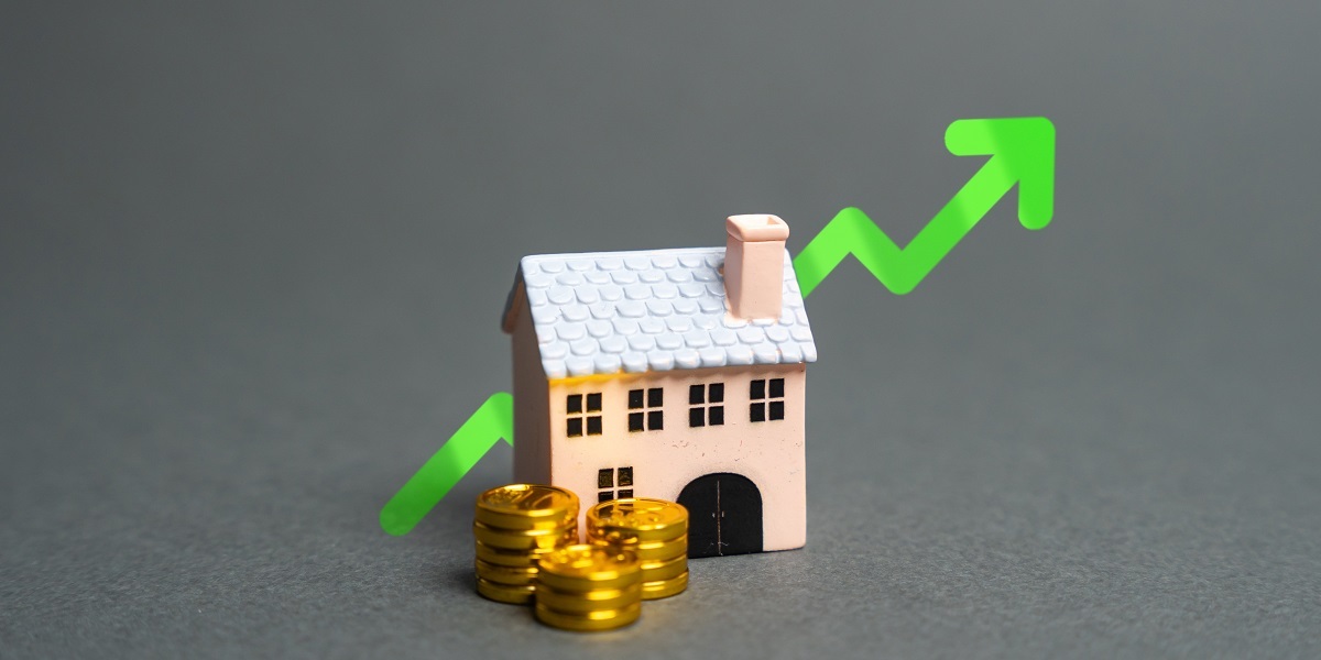 House with gold coins and green arrow pointing up