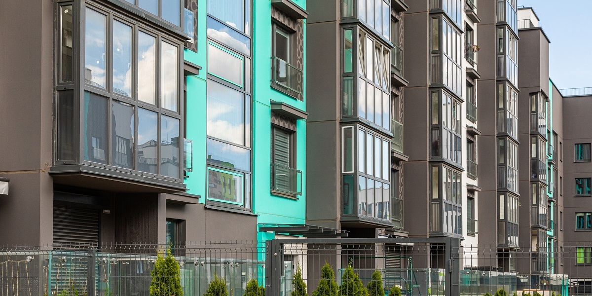 Side view of modern apartment building with clean glass balconies