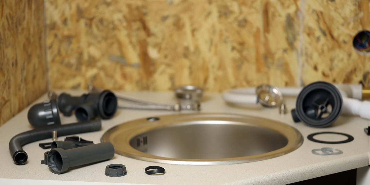 Tools and water tap ready for installation sink on countertop