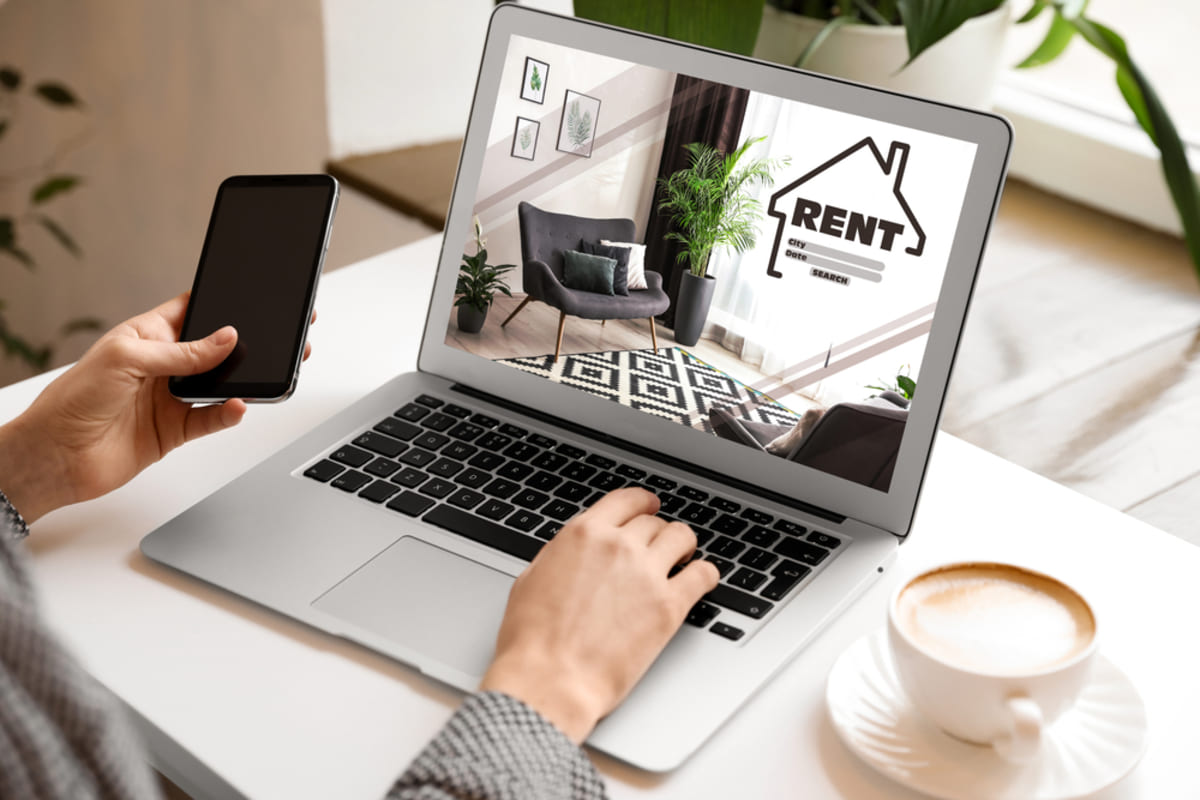 Woman searching for a rental property website via laptop.