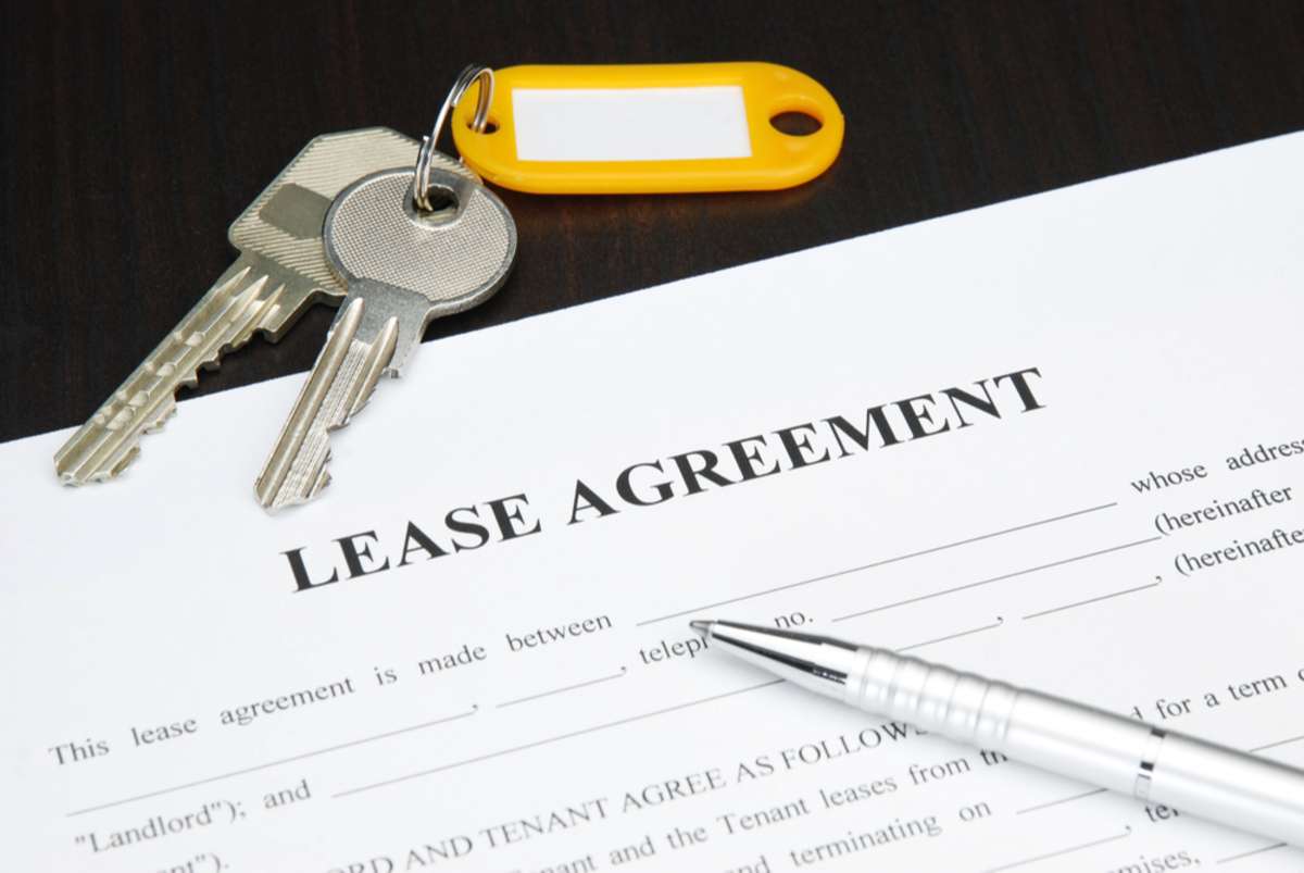 Lease agreement document with keys and pen