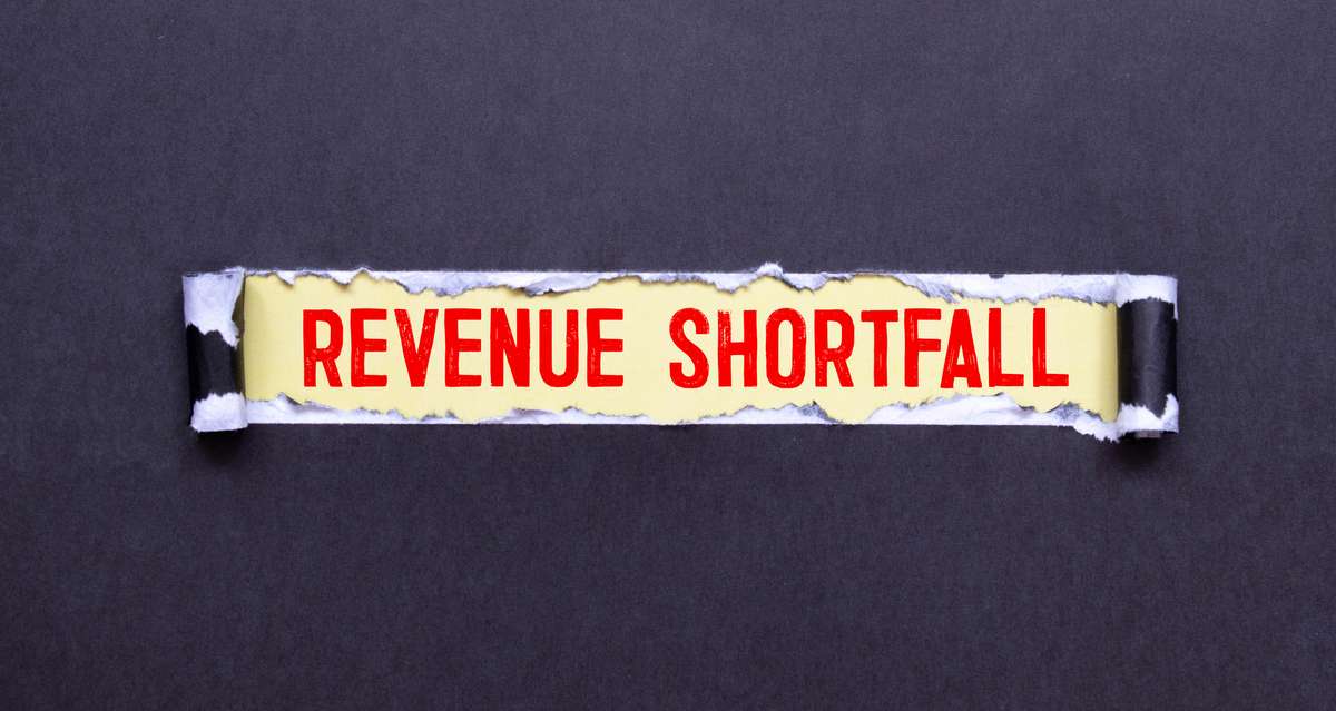The words Revenue Shortfall written on paper